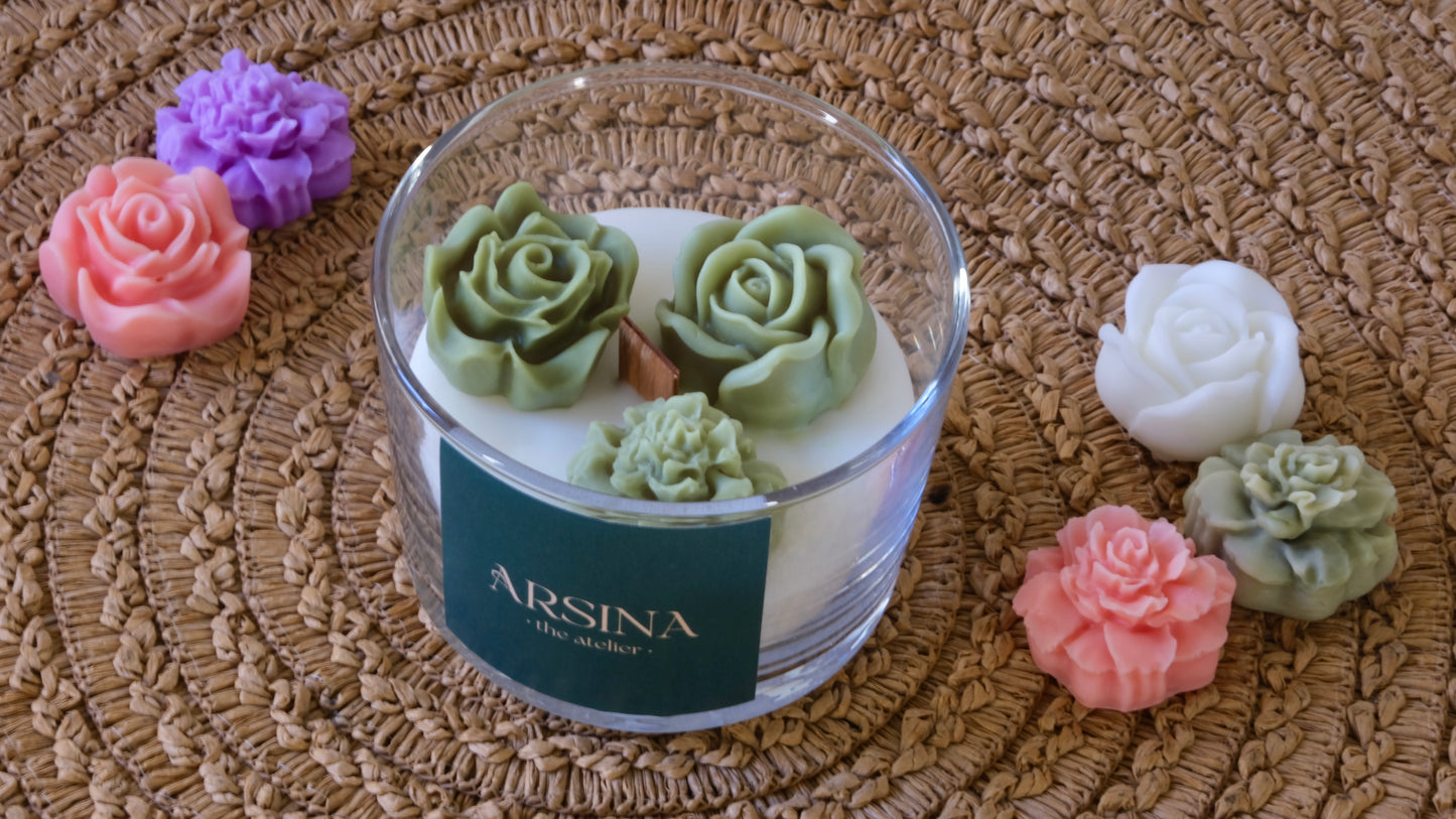 3 rose candles on top of a candle