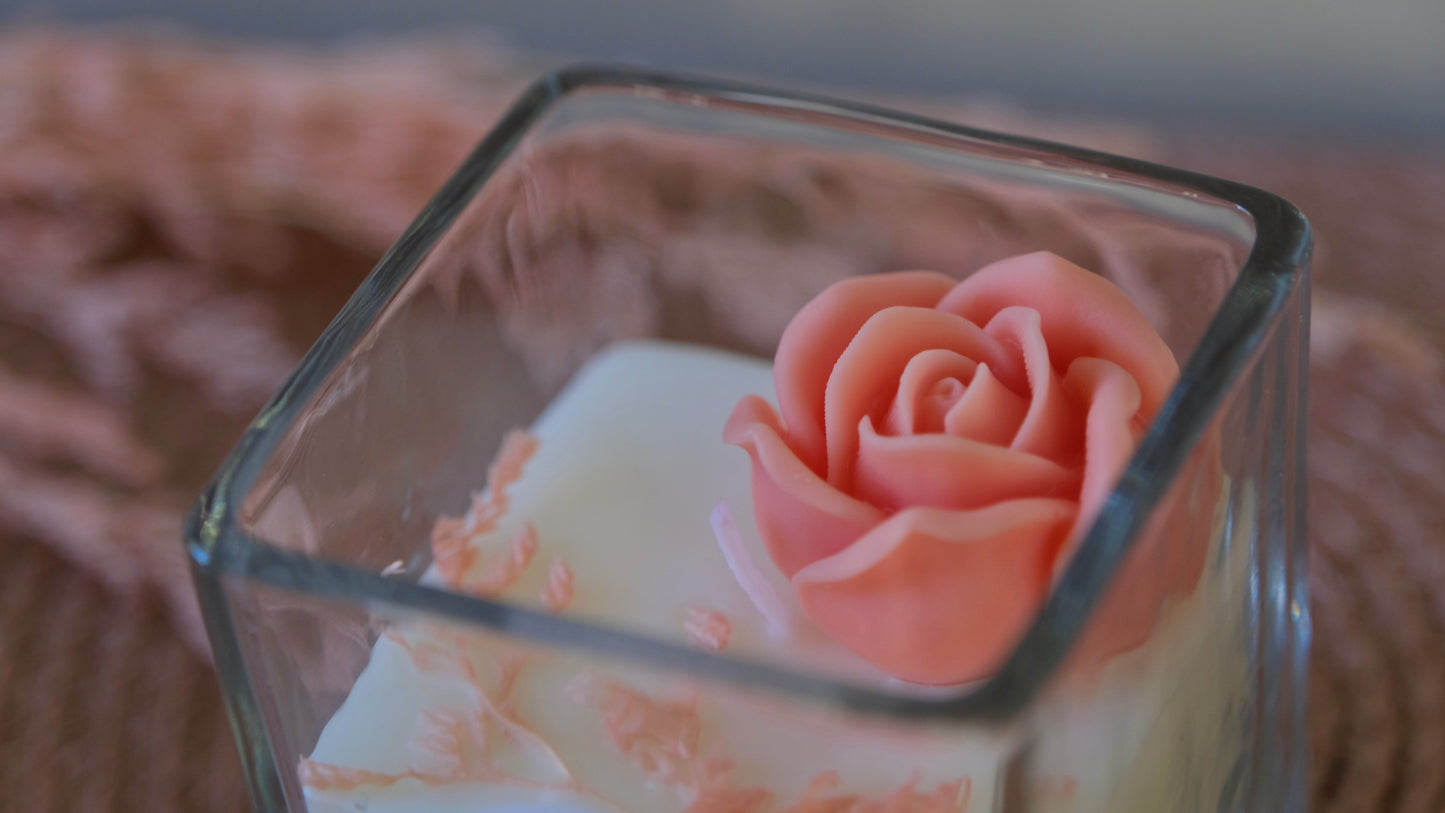Blush rose candle on top of white