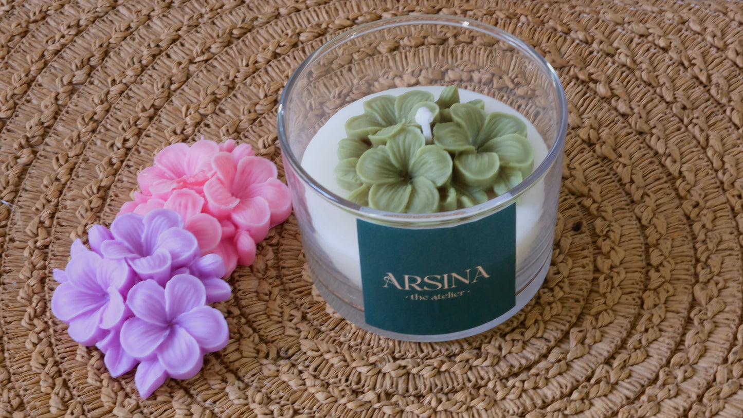 Plumeria flower candle with green, pink, and purple options